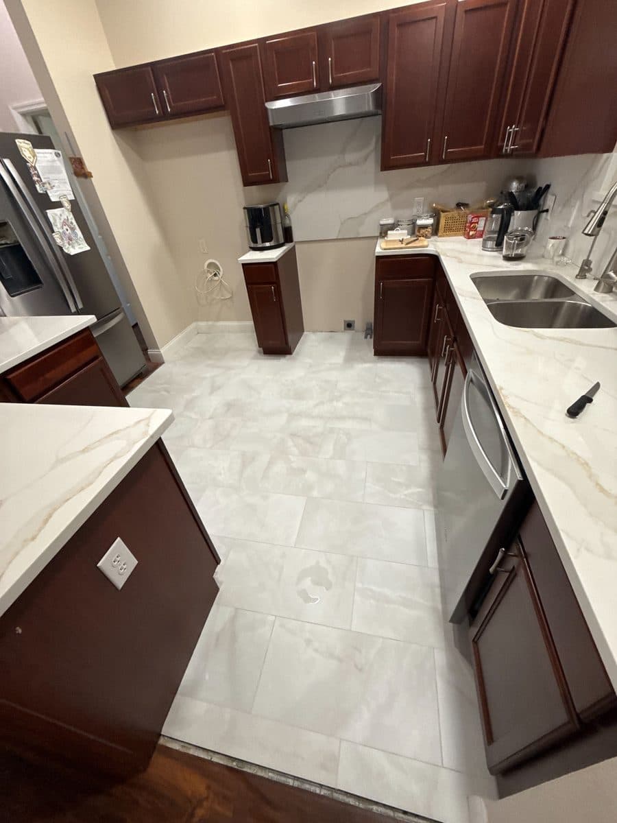 Marble-look porcelain kitchen floor installed by Black Gold Flooring